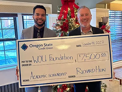 Jordan Carpenter, branch manager and Dr. Jesse Peters, WOU President - Scholarship donation